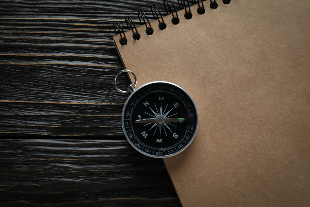Traveling, adventure and vacation concept with compass